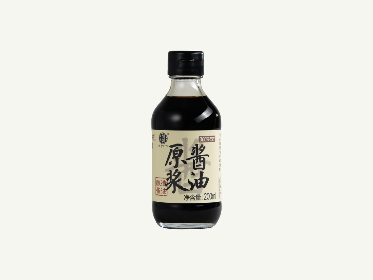A 200ml bottle of  Chinese soy sauce  with a black cap and a cream-colored label featuring black kanji characters, set against a plain off-white background.